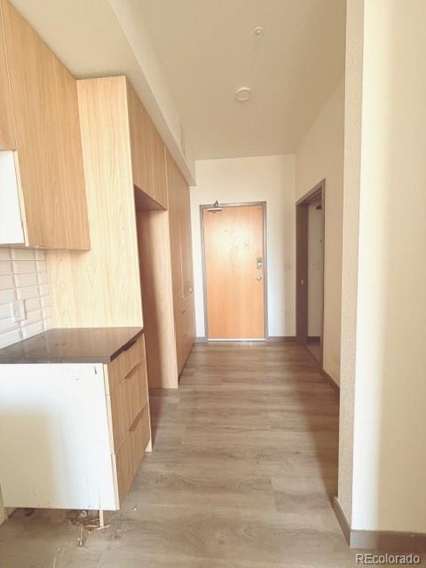 603 Inca Street, Unit 309 Denver, CO 80204 - Photo 10 of 12 a view of an empty room with window and a kitchen