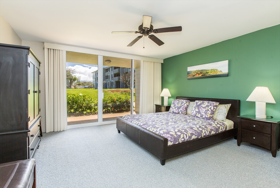 3811 Edward Road, Unit 8204 Princeville, HI 96722 - Photo 11 of 16 a bedroom with a bed and a large window