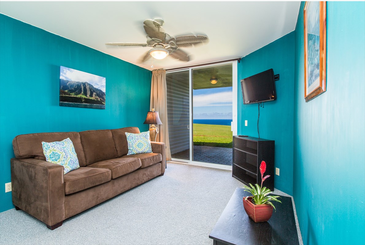 3811 Edward Road, Unit 8204 Princeville, HI 96722 - Photo 13 of 16 a living room with furniture and a flat screen tv