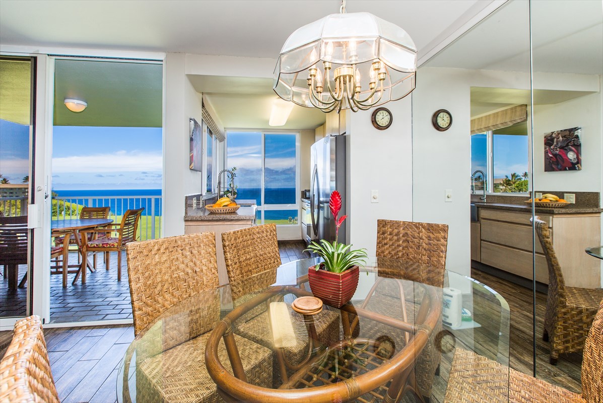 3811 Edward Road, Unit 8204 Princeville, HI 96722 - Photo 6 of 16 a dining room with furniture a kitchen and chandelier