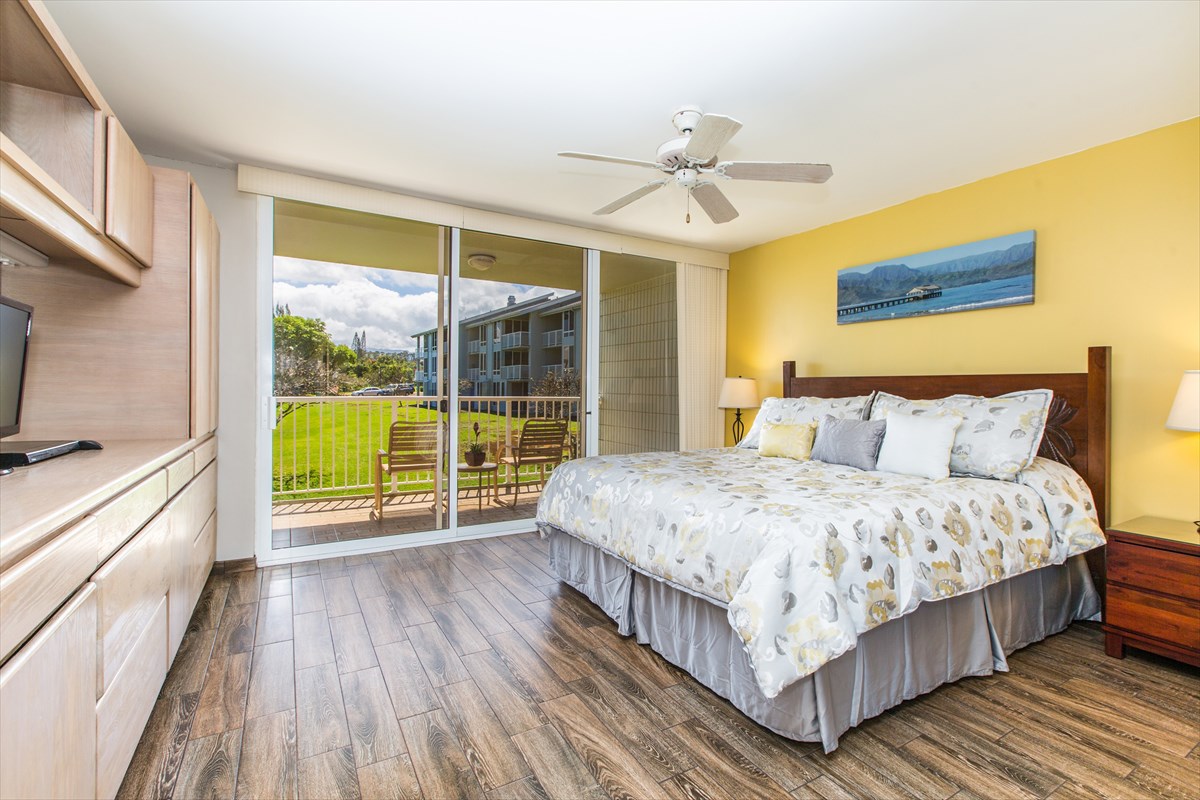 3811 Edward Road, Unit 8204 Princeville, HI 96722 - Photo 9 of 16 a bedroom with a bed and a large window with outer view
