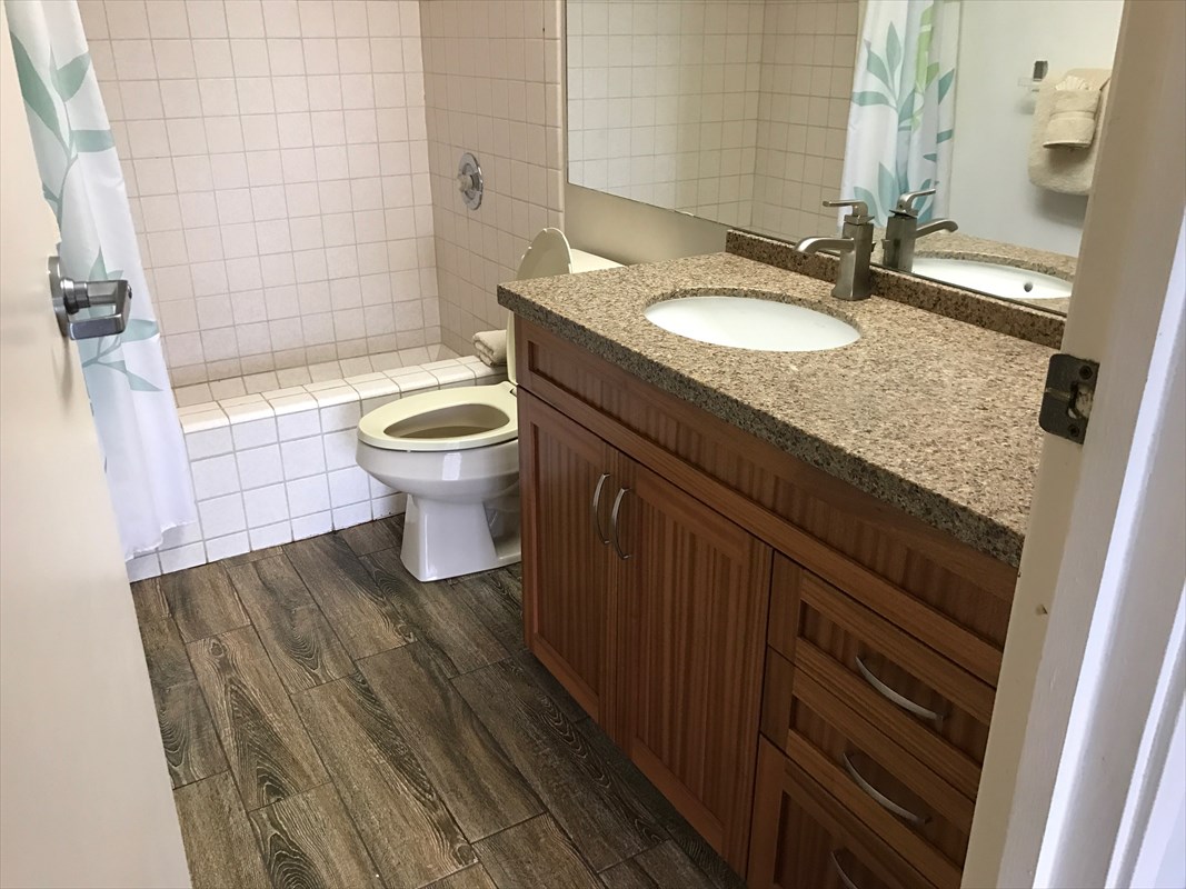 3811 Edward Road, Unit 8204 Princeville, HI 96722 - Photo 10 of 16 a bathroom with a granite countertop sink toilet and shower