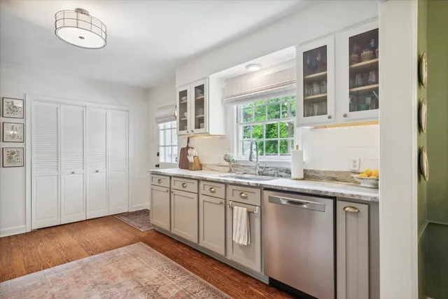 a kitchen with a sink cabinets and window