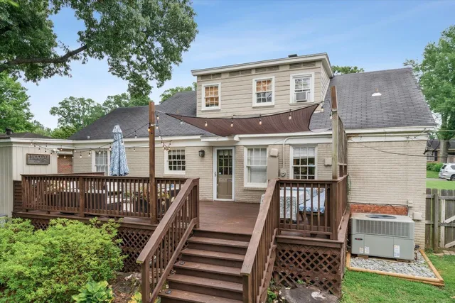 a view of a house with backyard and deck