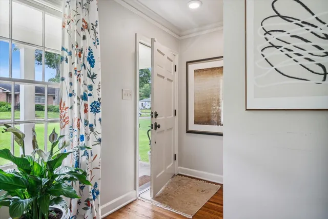 a view of a hallway with paintings on the wall
