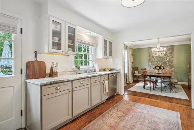 a kitchen with sink cabinets and dining table