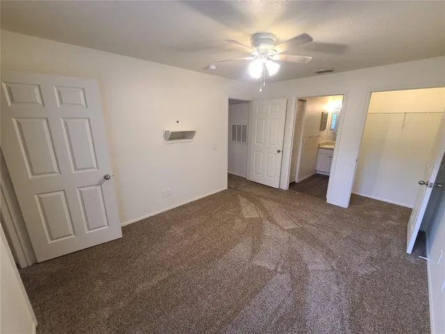 an empty room with windows and bathroom