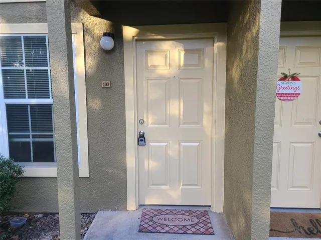 a view of a big room with windows and chandelier fan