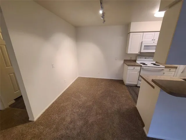 a kitchen with stove sink and cabinets