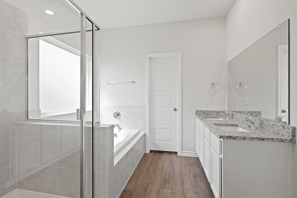 3112 Harmony Way Cleburne, TX 76031 - Photo 11 of 25 a bathroom with a granite countertop sink a mirror and a shower