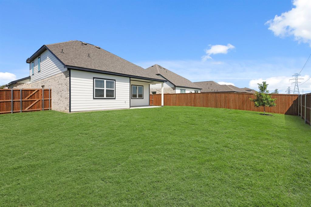3112 Harmony Way Cleburne, TX 76031 - Photo 18 of 25 a front view of house with yard and green space