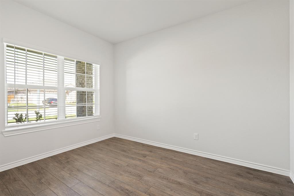 3112 Harmony Way Cleburne, TX 76031 - Photo 4 of 25 an empty room with wooden floor and windows