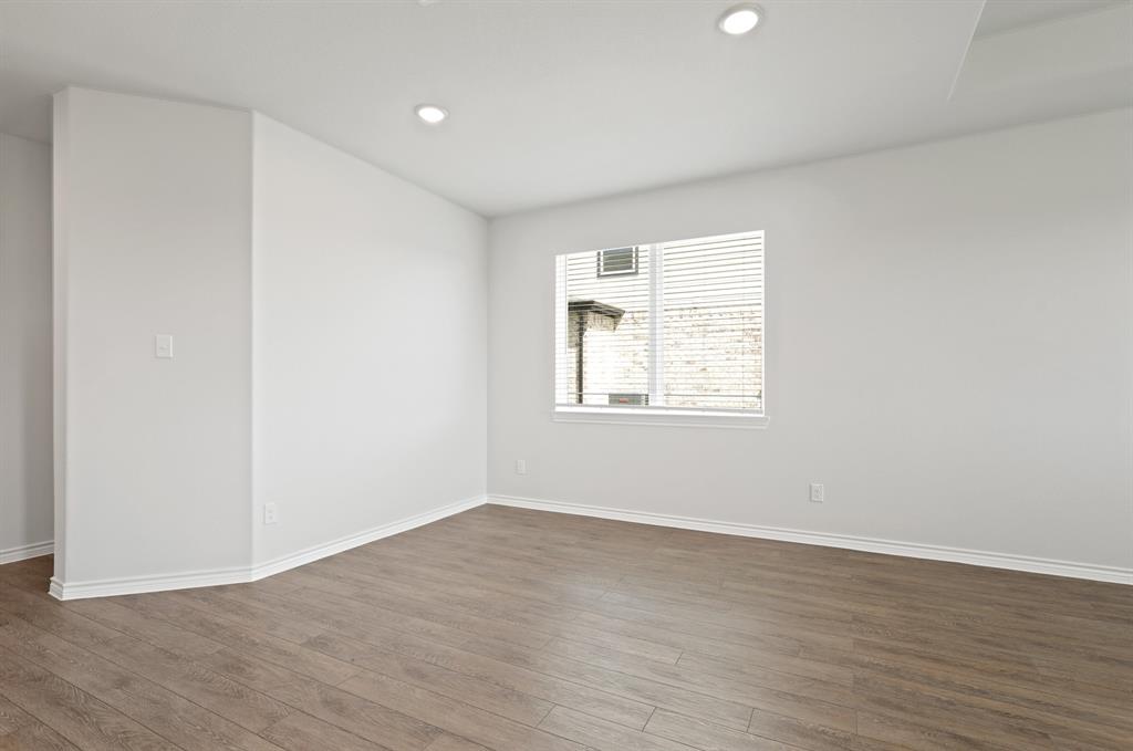 3112 Harmony Way Cleburne, TX 76031 - Photo 6 of 25 an empty room with wooden floor and windows