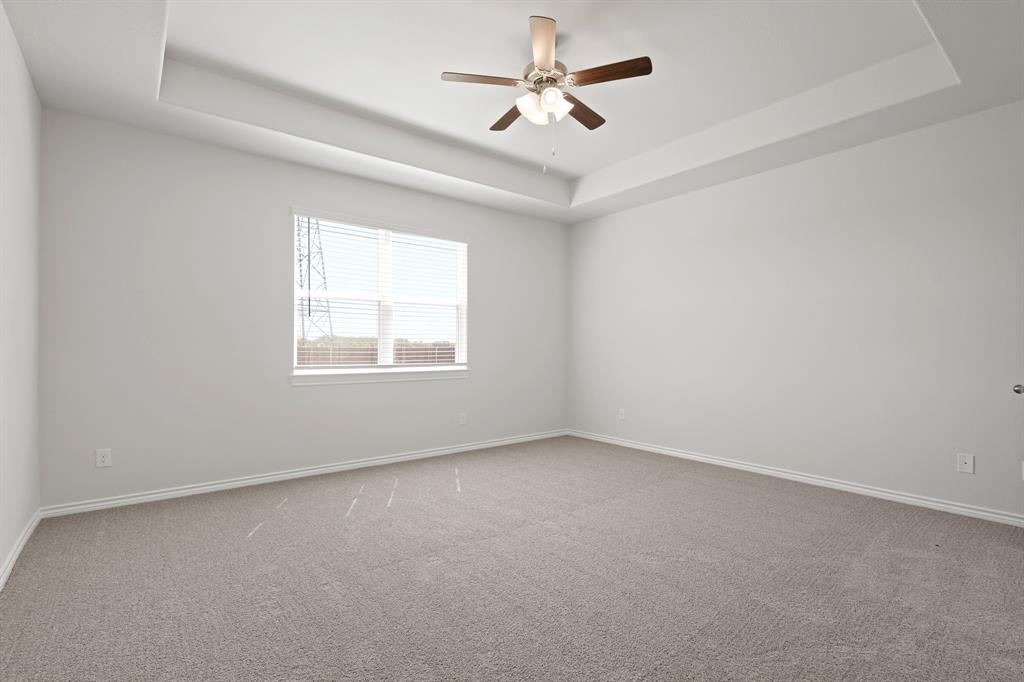 3112 Harmony Way Cleburne, TX 76031 - Photo 9 of 25 an empty room with a window and a fan