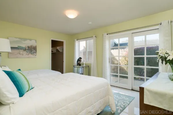 a spacious bedroom with a bed and a window