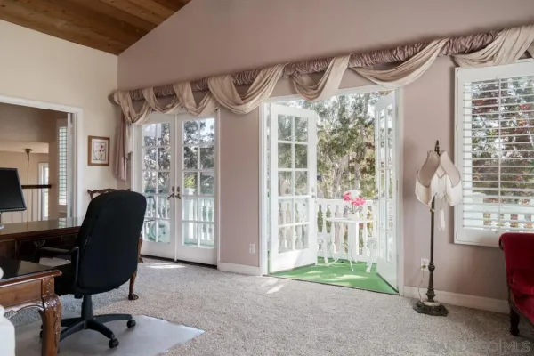 a livingroom with workspace and a window