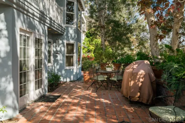 a view of a patio with table and chairs and potted plants