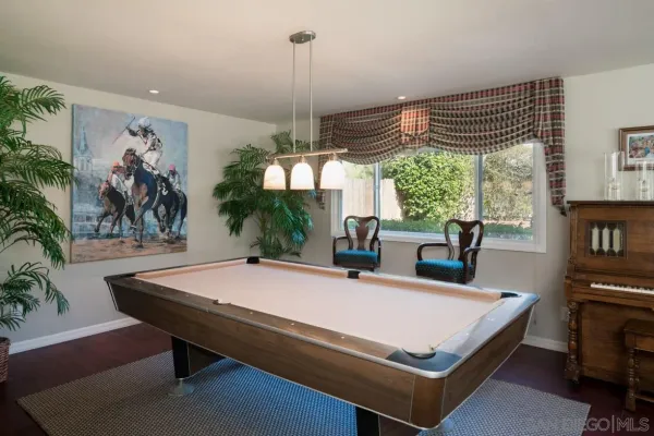 a living room with furniture a dining table and a potted plant