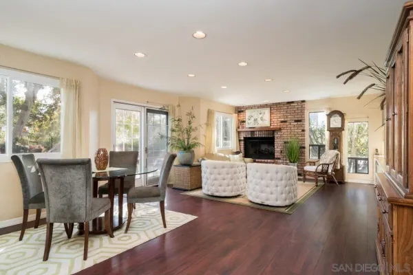 a living room with fireplace furniture and a large window