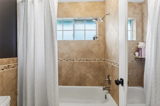 a bathroom with a glass shower door