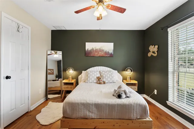 a bedroom with a bed and a chandelier