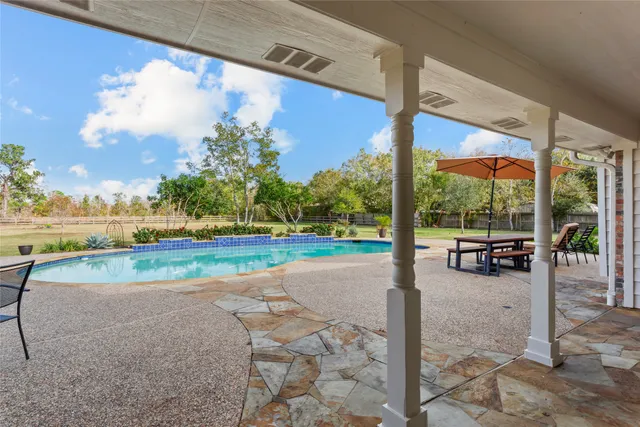 a view of a patio with a table and chairs