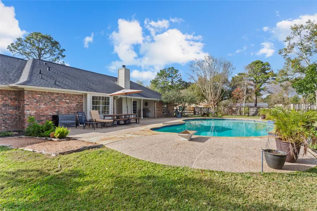 a view of a house with a yard and sitting area