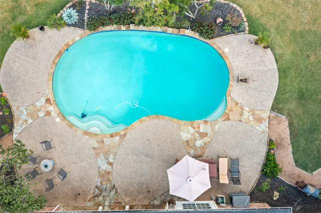 a view of a swimming pool with a table and chairs