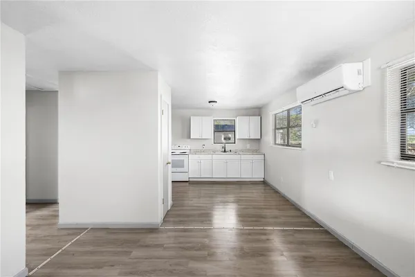 a kitchen with granite countertop white cabinets and white appliances