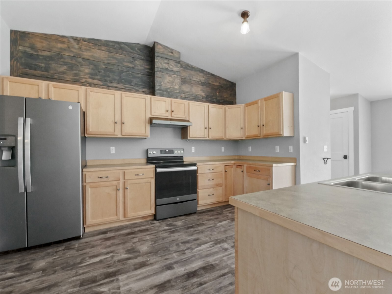 219 Jones Road Winlock, WA 98596 - Photo 12 of 35 a kitchen with stainless steel appliances a refrigerator sink and cabinets