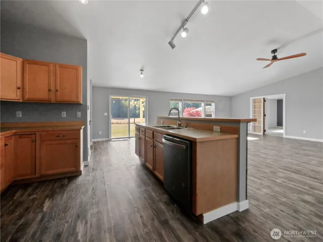 a kitchen with stainless steel appliances a stove and wooden floor
