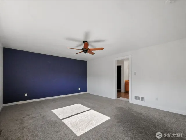 a view of a room with a ceiling fan