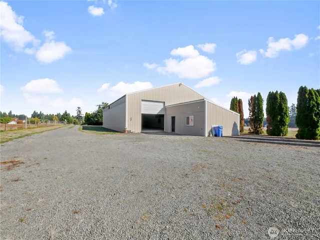 a view of a white house and a yard