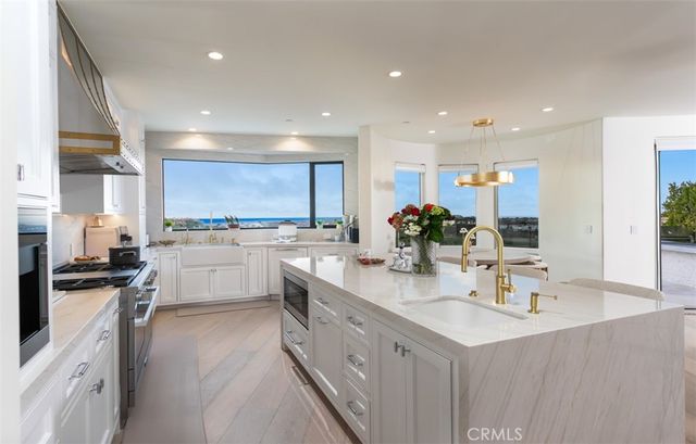 a kitchen with a sink stainless steel appliances and cabinets