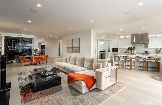 a living room with furniture and kitchen view