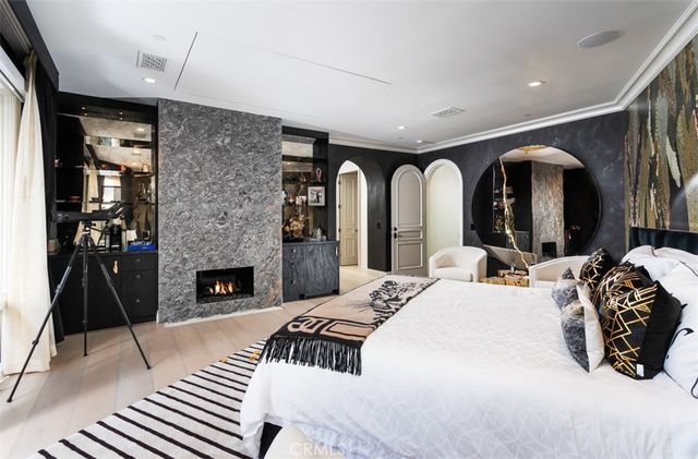 a bedroom with a bed and a fireplace