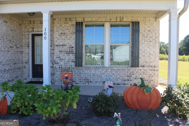 a brick building with a yard and a bench
