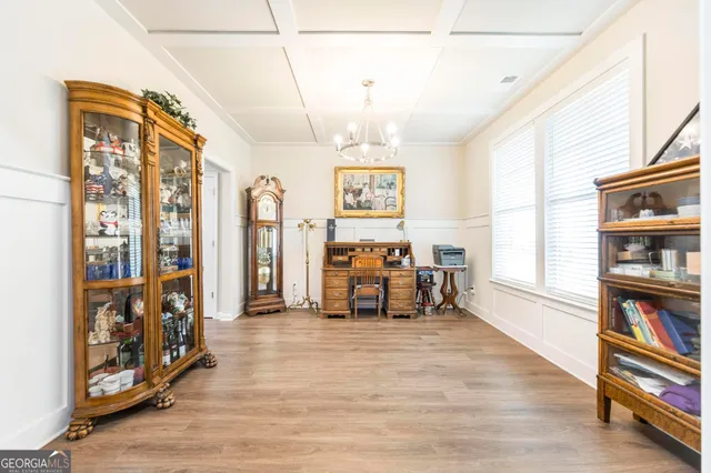 a view of a livingroom with furniture and a book shelf