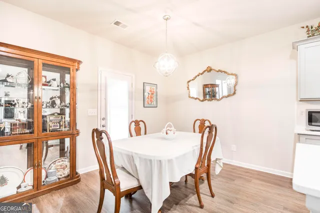 a view of a dining room with furniture wooden floor and a window