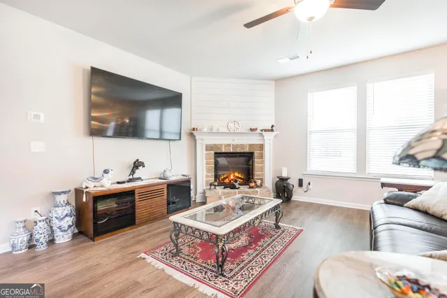 a living room with furniture a flat screen tv and a fireplace