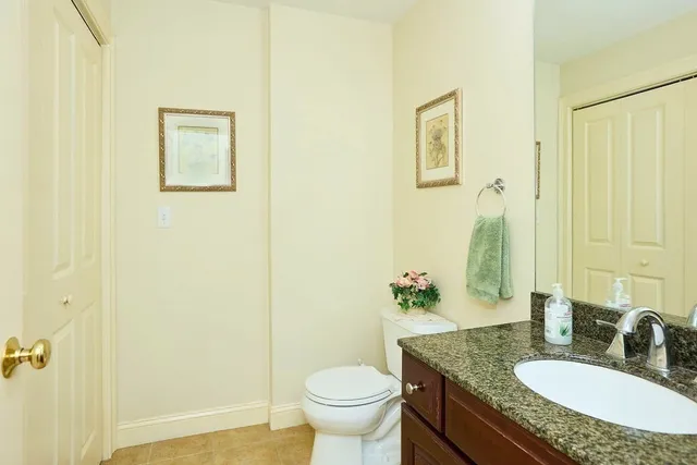 a bathroom with a granite countertop sink toilet a mirror and shower