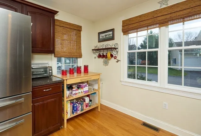 a dining room with furniture and wooden floor