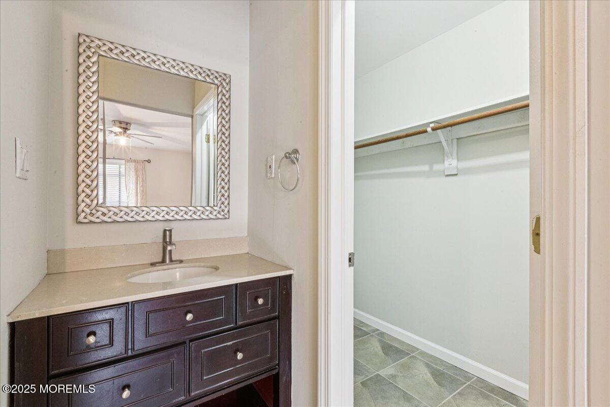 70 Overlook Way, Unit E Manalapan, NJ 07726 - Photo 12 of 21 a bathroom with a sink and a mirror