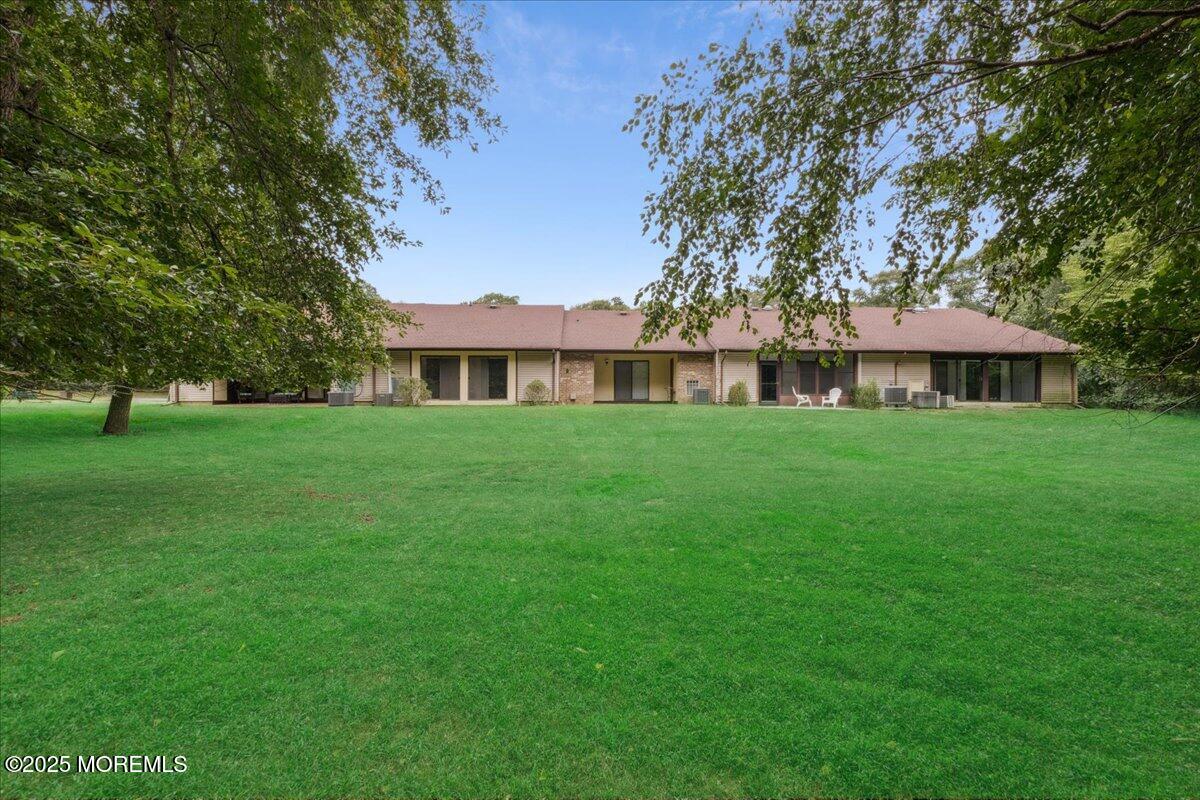 70 Overlook Way, Unit E Manalapan, NJ 07726 - Photo 18 of 21 a view of a house with a yard