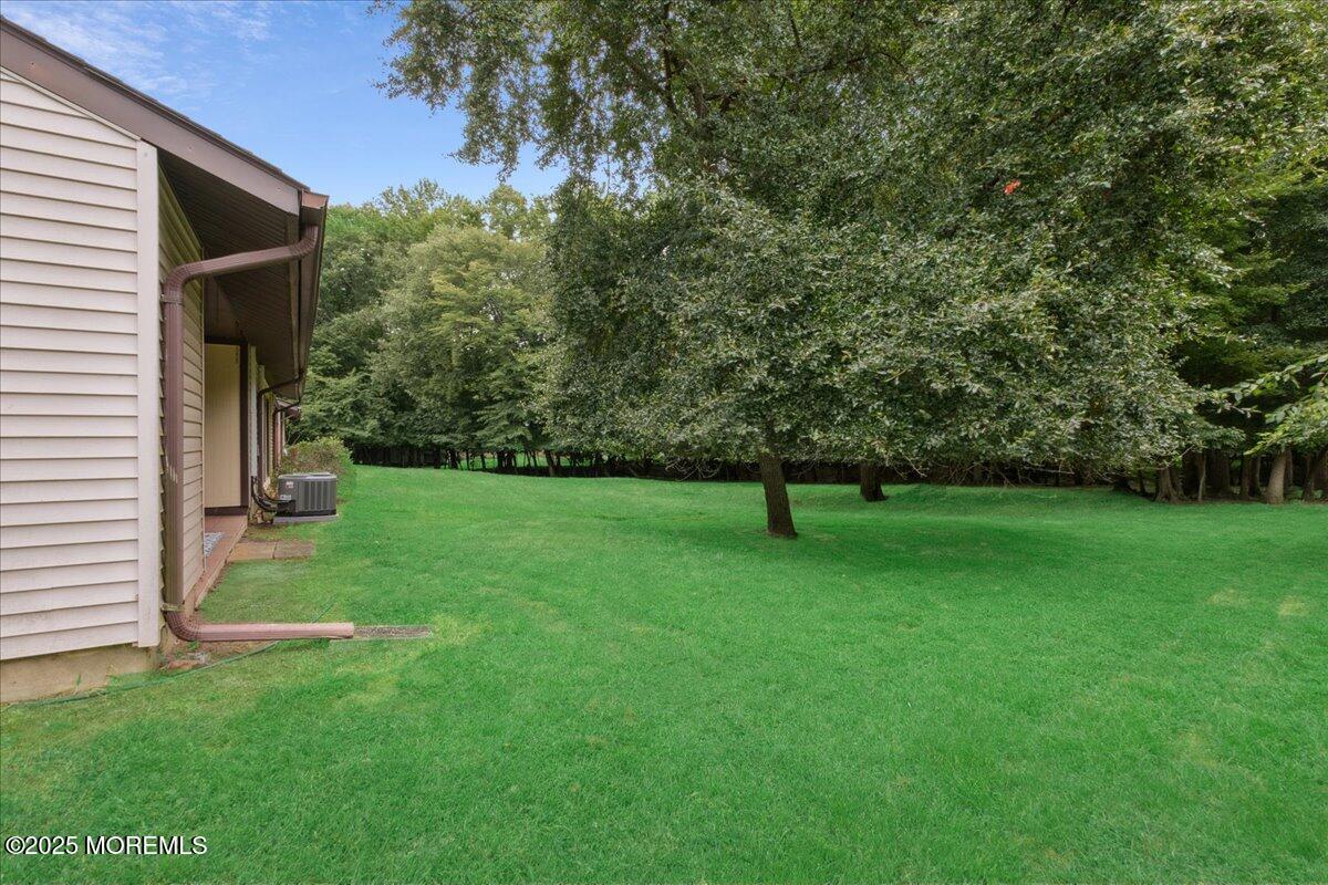 70 Overlook Way, Unit E Manalapan, NJ 07726 - Photo 20 of 21 a view of a backyard with a garden