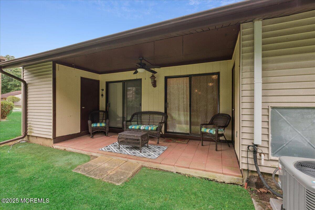 70 Overlook Way, Unit E Manalapan, NJ 07726 - Photo 21 of 21 a backyard of a house with outdoor seating