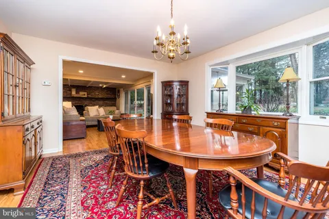 a dining room with furniture a rug and a chandelier