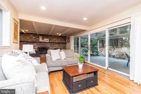 a living room with furniture a fireplace and a table