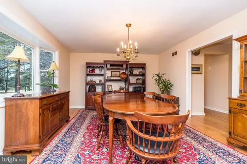 a dining room with furniture a rug and wooden floor