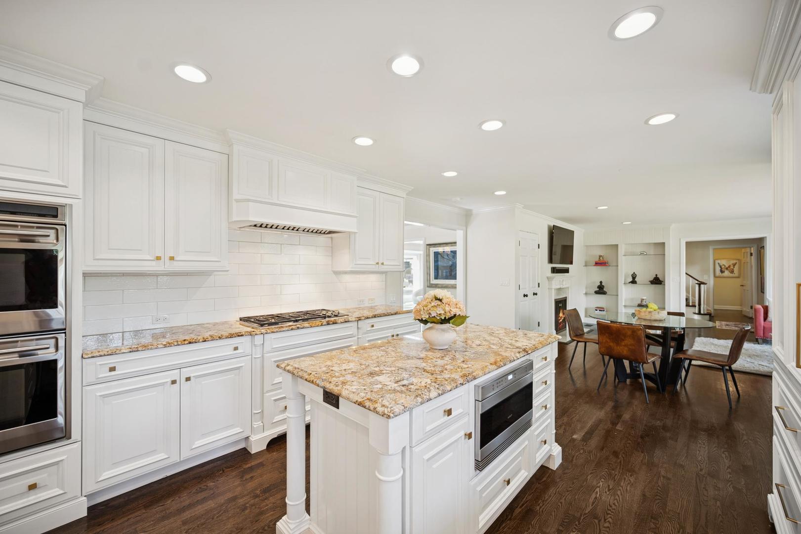 32 Meadowview Road Northfield, IL 60093 - Photo 23 of 69 a open kitchen with granite countertop a stove top oven a sink a counter space and dining table